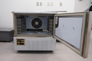 a photo of a blast chiller with the door open to the right and the interior exposed