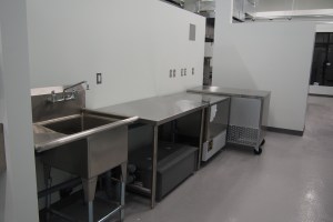 commercial kitchen with stainless steel tables and a fast freezer machine