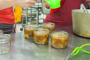 Pouring the plum chutney into jars.