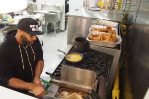 Chef LeRoy frying up chicken and making Mac n Cheese.